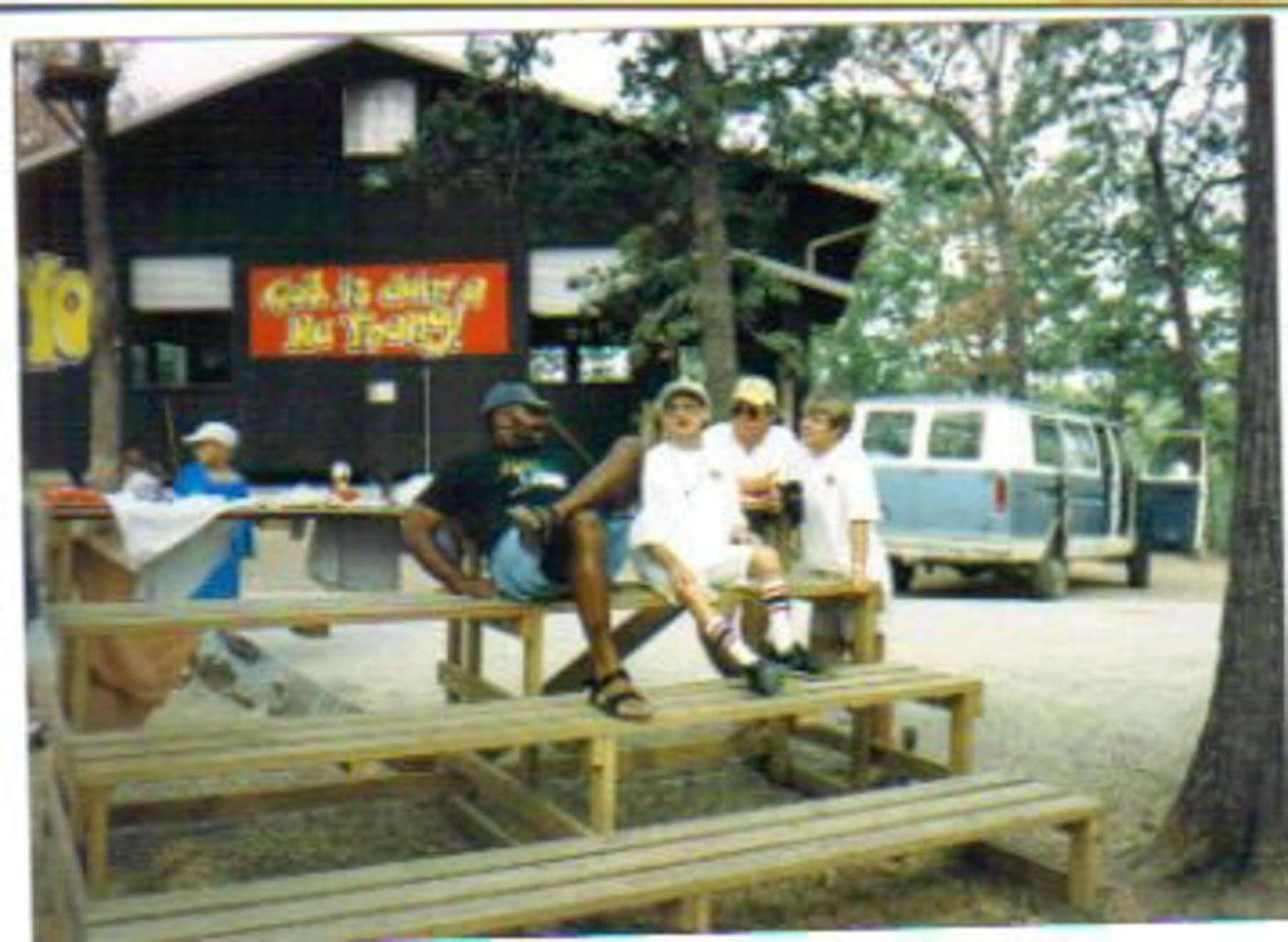 Camp counselors sitting on bleachers at Camp Barnabas