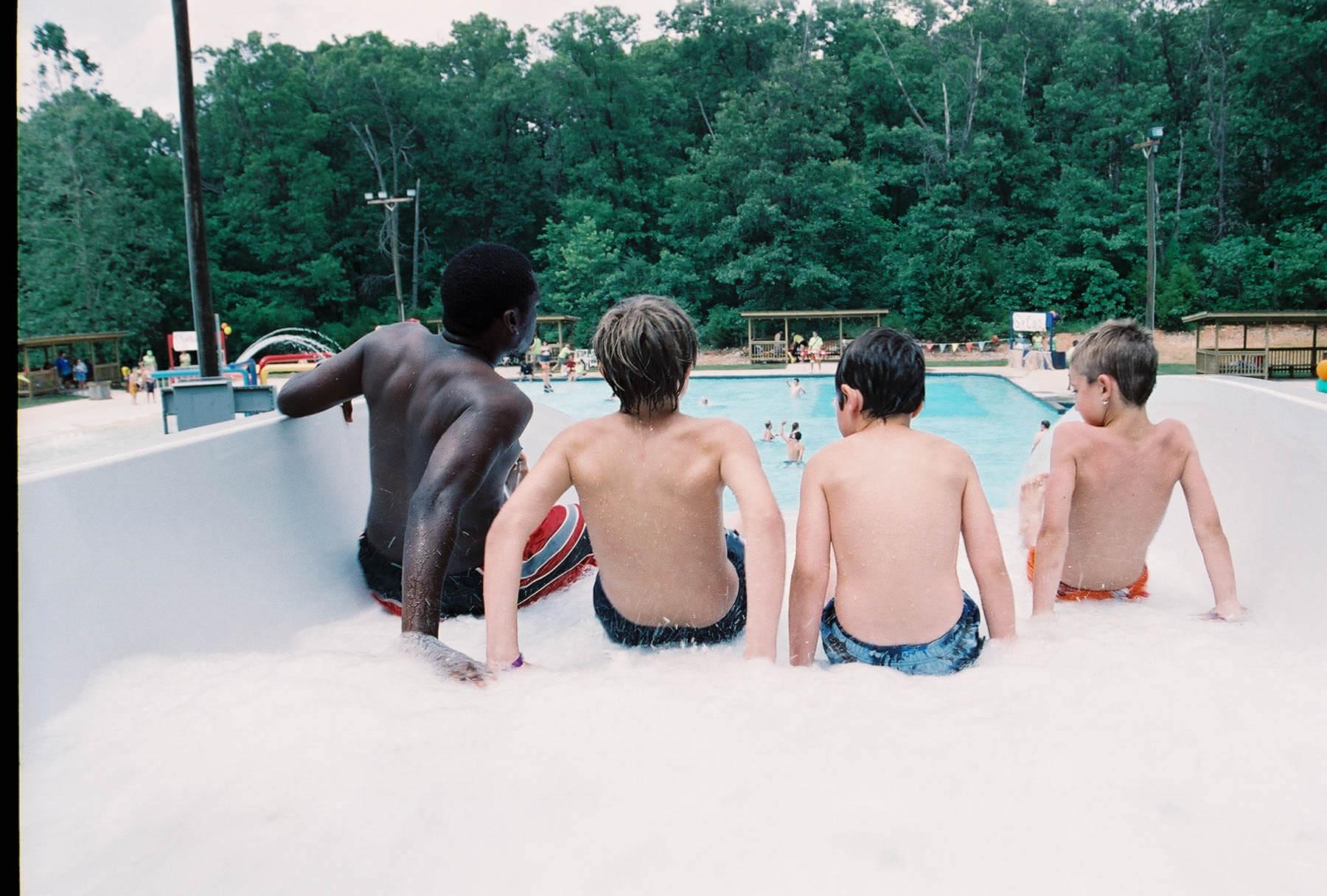 Kids swimming at a summer camp pool