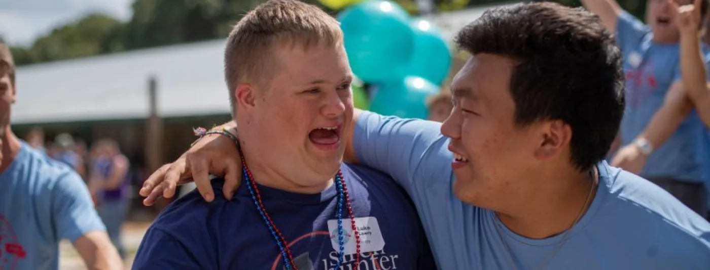 Staffer putting his arm around a camper