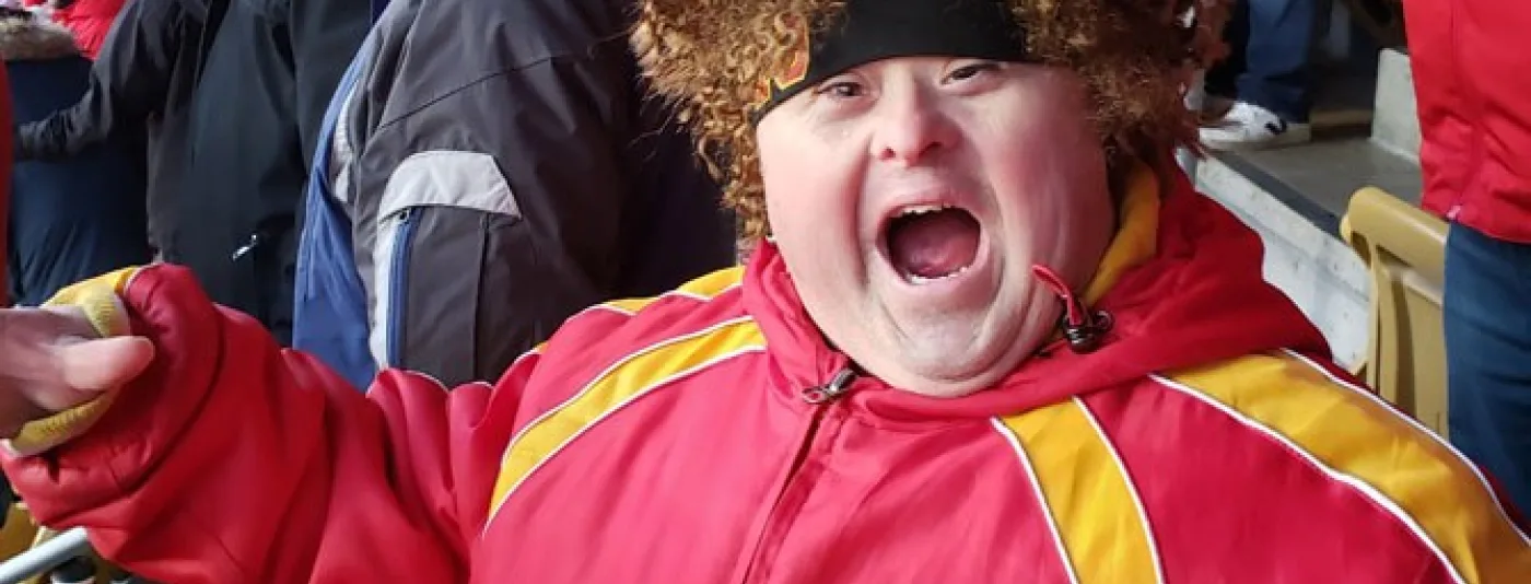 Young boy wearing a Kansas City Chiefs jacket at a game