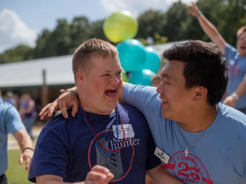 Staffer putting his arm around a camper