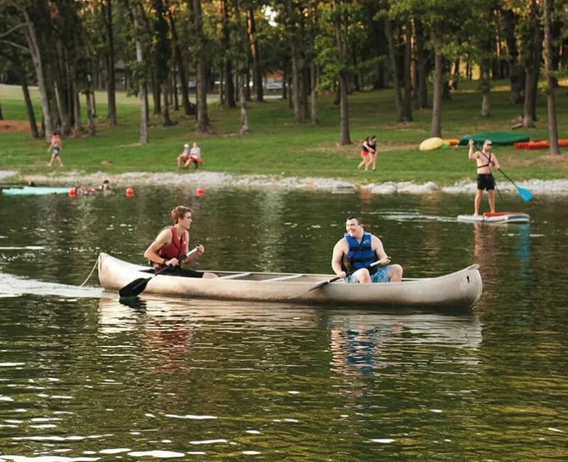 Two campers on a canoe in the lake.